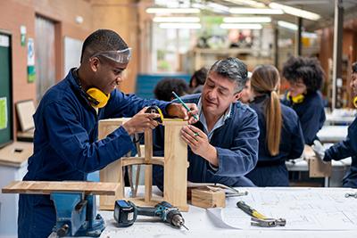 A student and teacher work on a project